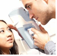 An Optometrist Using A Keeler Pulsair IntelliPuff Non Contact Tonometer On A Patient
